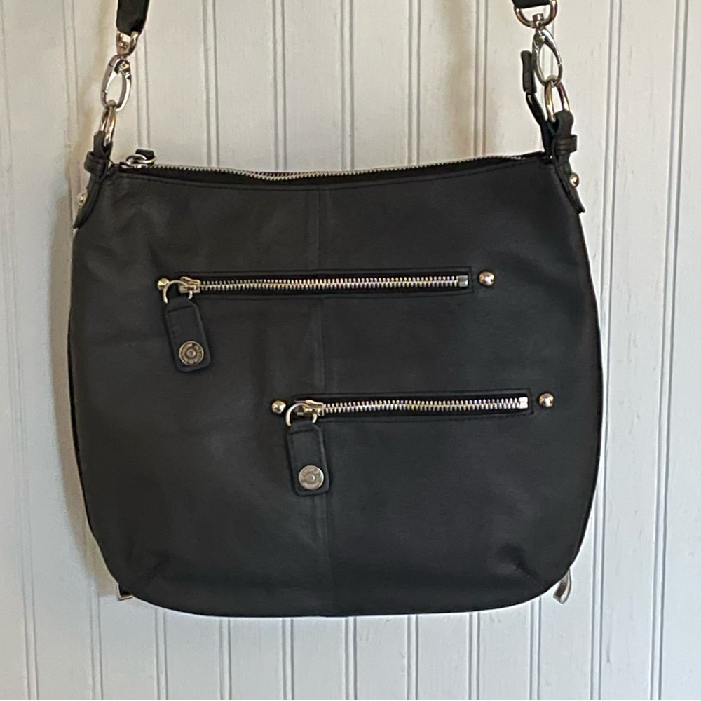 Black leather purse with concealed carry compartment for handgun.  Never used.